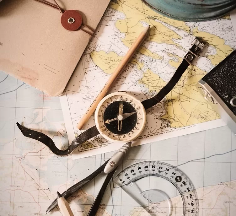 tudent analyzing a nautical chart and plotting navigation routes